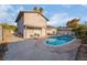 Private backyard features a sparkling pool and a relaxing outdoor living space at 608 Cragin Park Dr, Las Vegas, NV 89107