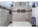 Elegant tile design with a shower-tub combination and sleek, modern fixtures at 608 Cragin Park Dr, Las Vegas, NV 89107