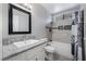 Bathroom features granite countertop, framed mirror, and tiled shower-tub combination at 608 Cragin Park Dr, Las Vegas, NV 89107