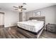 Cozy bedroom with a large bed, wood floors, and a ceiling fan at 608 Cragin Park Dr, Las Vegas, NV 89107