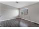 Empty bedroom featuring gray walls, laminate flooring, and natural light at 608 Cragin Park Dr, Las Vegas, NV 89107