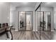 Spacious main bedroom featuring wood floors, gray walls, and mirrored sliding closet doors at 608 Cragin Park Dr, Las Vegas, NV 89107