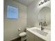 Clean bathroom with white vanity, round mirror, and neutral decor at 6240 Winston Falls Ave, Las Vegas, NV 89139