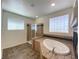 Bathroom showcasing a soaking tub, shower, and tile flooring at 6240 Winston Falls Ave, Las Vegas, NV 89139