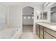 Bright bathroom features a soaking tub and dual sink vanity with granite countertops at 6679 Salt Pond Bay St, Las Vegas, NV 89149