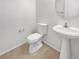 Cozy half bathroom showcasing a modern pedestal sink and tile flooring at 7211 Hickory Post Ave, Las Vegas, NV 89179