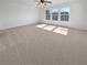 Spacious bedroom filled with natural light featuring neutral carpet and three windows at 7211 Hickory Post Ave, Las Vegas, NV 89179