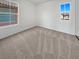Empty bedroom with carpet flooring featuring two large windows and one small window at 7211 Hickory Post Ave, Las Vegas, NV 89179