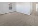 Bright bedroom featuring neutral carpet, natural light from the window, and modern wall paint at 7211 Hickory Post Ave, Las Vegas, NV 89179