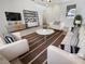 Bright living room with modern furniture and a view to the front of the home at 7211 Hickory Post Ave, Las Vegas, NV 89179
