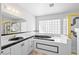 Modern bathroom with a soaking tub, black accents, and a glass-enclosed shower at 736 N Kiel St, Henderson, NV 89015