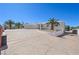 Expansive driveway leading to a two car garage with a desert landscape in front of the home at 736 N Kiel St, Henderson, NV 89015