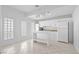 Bright kitchen with white cabinets, modern appliances, and tiled floors with a kitchen island at 736 N Kiel St, Henderson, NV 89015