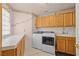 Bright laundry room with modern washer and dryer, ample counter space, and upper cabinets at 736 N Kiel St, Henderson, NV 89015