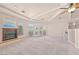 Bright living room boasts neutral carpet, exposed beams, and a modern fireplace at 736 N Kiel St, Henderson, NV 89015