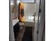 Well-lit bathroom featuring a shower-tub combo with a sunflower curtain and dark wood cabinets at 742 Agave Falls St, Henderson, NV 89011