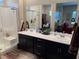 Modern bathroom featuring a glass-enclosed shower, dual vanity sinks, and elegant fixtures at 742 Agave Falls St, Henderson, NV 89011