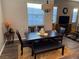 Stylish dining area with modern table and chairs, ample natural light, and view into the living room at 742 Agave Falls St, Henderson, NV 89011