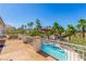 This balcony overlooks a refreshing swimming pool, palm trees and the neighborhood at 7808 Foothill Ash Ave, Las Vegas, NV 89117