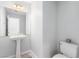 Cozy powder room featuring a pedestal sink and modern toilet at 7808 Foothill Ash Ave, Las Vegas, NV 89117
