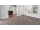 Bedroom boasts neutral carpet and an open view to an adjacent fireplace at 7808 Foothill Ash Ave, Las Vegas, NV 89117
