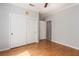 Bedroom with hardwood floors, a ceiling fan, and a large closet with sliding doors at 7808 Foothill Ash Ave, Las Vegas, NV 89117