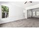 Bright bedroom featuring neutral carpet, large windows, and ample closet space at 7808 Foothill Ash Ave, Las Vegas, NV 89117