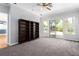 Bonus room with carpet, a ceiling fan, and views of the pool area at 7808 Foothill Ash Ave, Las Vegas, NV 89117