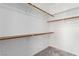 Walk-in closet with shelving, wooden closet rods, and plush carpeting at 7808 Foothill Ash Ave, Las Vegas, NV 89117