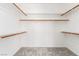 Spacious walk-in closet with built-in shelves and wooden closet rods at 7808 Foothill Ash Ave, Las Vegas, NV 89117