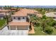 Aerial view of a single-Gathering home featuring a three-car garage and tile roof in a desert landscaped neighborhood at 7808 Foothill Ash Ave, Las Vegas, NV 89117