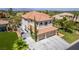 Aerial view of a two-story house with desert landscaping, tile roof, and three-car garage at 7808 Foothill Ash Ave, Las Vegas, NV 89117