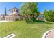Charming two-story home with a well-manicured lawn, lush trees, and a spacious two-car garage at 7808 Foothill Ash Ave, Las Vegas, NV 89117