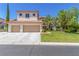 Charming two-story home with a well-manicured lawn, lush trees, and a spacious two-car garage at 7808 Foothill Ash Ave, Las Vegas, NV 89117