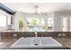 Kitchen sink and granite counter with a view of the pool and backyard at 7808 Foothill Ash Ave, Las Vegas, NV 89117
