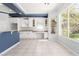 Bright kitchen with white cabinets, granite counters, and a large window overlooking the backyard at 7808 Foothill Ash Ave, Las Vegas, NV 89117