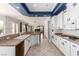 Modern kitchen featuring white cabinets, stainless steel appliances, granite countertops, and blue ceiling at 7808 Foothill Ash Ave, Las Vegas, NV 89117