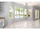 Bright living area with tile flooring, large windows, and pool view at 7808 Foothill Ash Ave, Las Vegas, NV 89117
