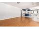 Open floor plan with hardwood floors connecting the living area to the kitchen with island at 7808 Foothill Ash Ave, Las Vegas, NV 89117