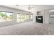 Spacious living room featuring a fireplace, ceiling fan, and access to the backyard at 7808 Foothill Ash Ave, Las Vegas, NV 89117