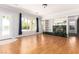 Spacious living room with hardwood floors, fireplace, and a view of the pool at 7808 Foothill Ash Ave, Las Vegas, NV 89117
