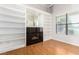 Living area with a fireplace and built-in shelves, complemented by light wood floors at 7808 Foothill Ash Ave, Las Vegas, NV 89117