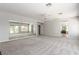 Expansive living room with a mirrored wall, ceiling fan and backyard access at 7808 Foothill Ash Ave, Las Vegas, NV 89117