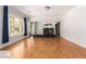 Bright living room featuring a fireplace, built-in shelves, hardwood floors, and a large window at 7808 Foothill Ash Ave, Las Vegas, NV 89117