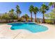 Backyard view of freeform pool and spa surrounded by lush landscaping and patio at 7808 Foothill Ash Ave, Las Vegas, NV 89117