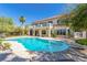 Luxurious backyard featuring a large pool, manicured lawn, and elegant home exterior at 7808 Foothill Ash Ave, Las Vegas, NV 89117