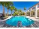 Backyard view of the pool, the diving board and patio, with house and palm trees around at 7808 Foothill Ash Ave, Las Vegas, NV 89117