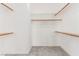 Large walk-in closet with open shelving and rods providing great storage options at 7808 Foothill Ash Ave, Las Vegas, NV 89117