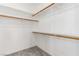 Spacious walk-in closet featuring ample shelving and wooden bars for organized storage at 7808 Foothill Ash Ave, Las Vegas, NV 89117