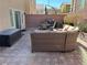 A large backyard patio with a dining table and a comfortable sectional for outdoor relaxation and entertainment at 8113 Mineola Palms St, Las Vegas, NV 89139